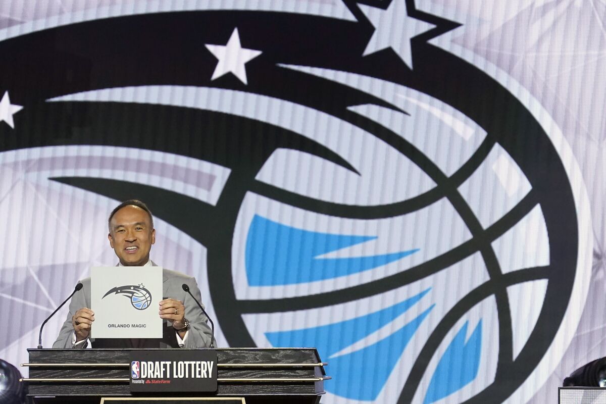 NBA Deputy Commissioner Mark Tatum announces that the Orlando Magic have won the first pick in the 2022 NBA draft during the NBA basketball draft lottery Tuesday, May 17, 2022, in Chicago. (AP Photo/Charles Rex Arbogast)