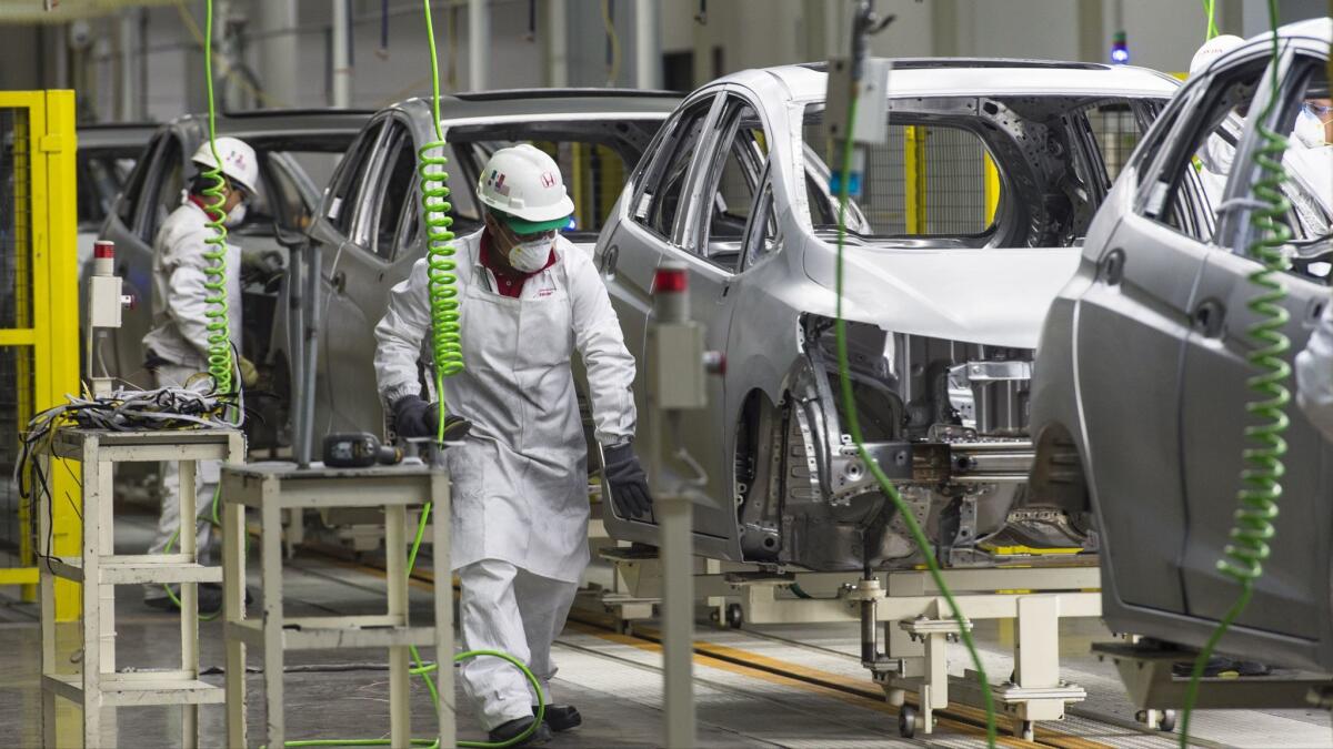 Workers at the assembly line of the recently opened Honda Motors factory in Celaya, Mexico.