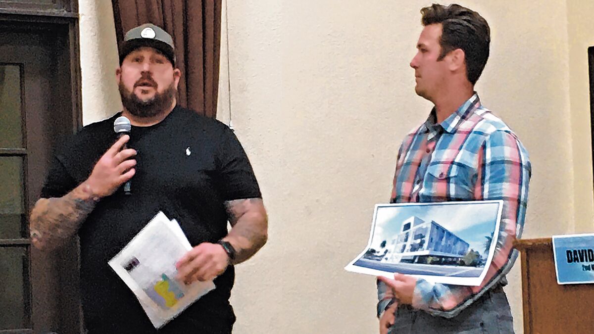 Derek Marso, left, of Valley Farm Market and Russ Murfey of Murfey Company present information to La Jolla Community Planning Association, Nov. 7, 2019, concerning the renovated building on La Jolla Boulevard at Nautilus Street, where the market is scheduled to open before the end of the year.