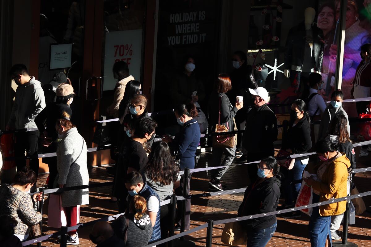 Black Friday shoppers wait in line 