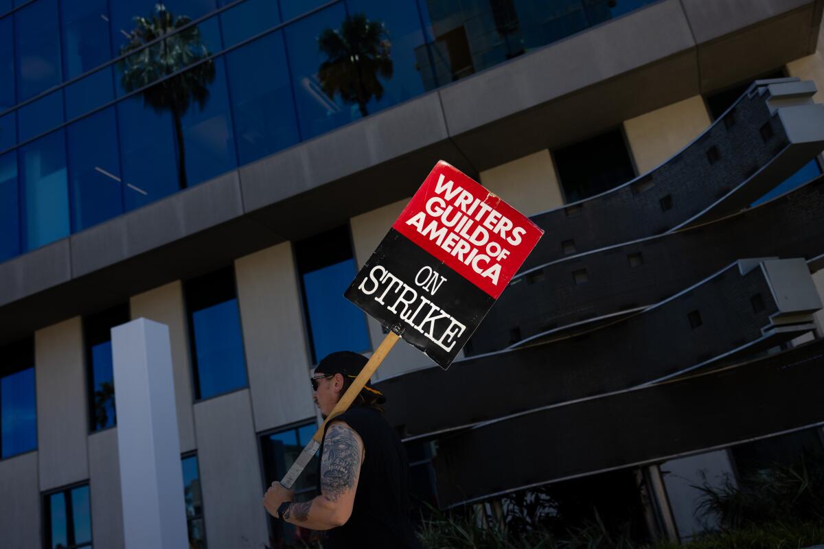 Picketers march in front of Netflix in Los Angeles.
