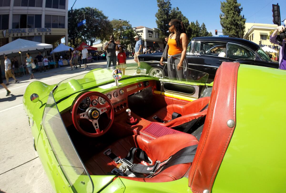 A 1957 Lotus 11 makes a perfect background for photos at the annual Downtown Burbank Car Classic on San Fernando Road in Burbank on Saturday, July 26, 2014.