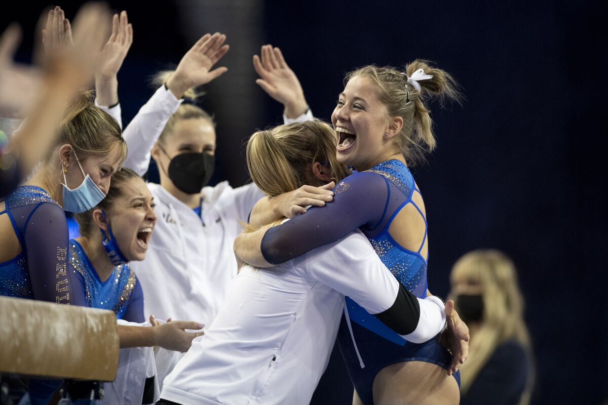 UCLA's Ana Padurariu is congratulated after her performance on the balance beam during a meet on Jan 30