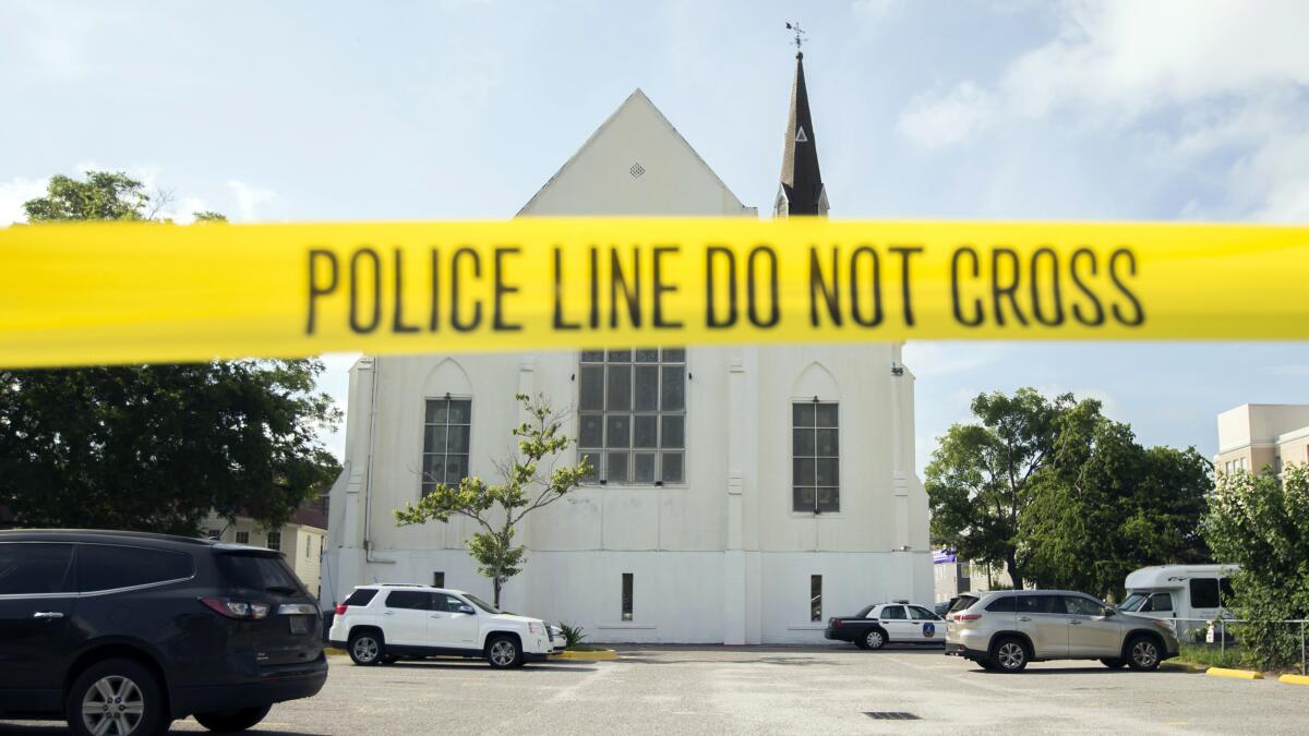 Police tape surrounds the parking lot behind the AME Emanuel Church in Charleston, S.C.