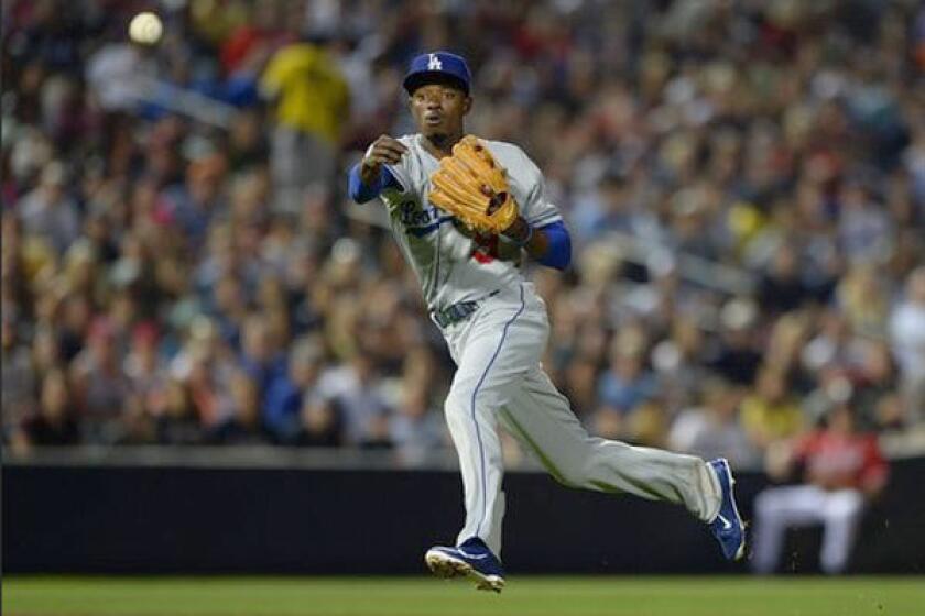 Dee Gordon makes a throw while playing shortstop for the Dodgers back in May.