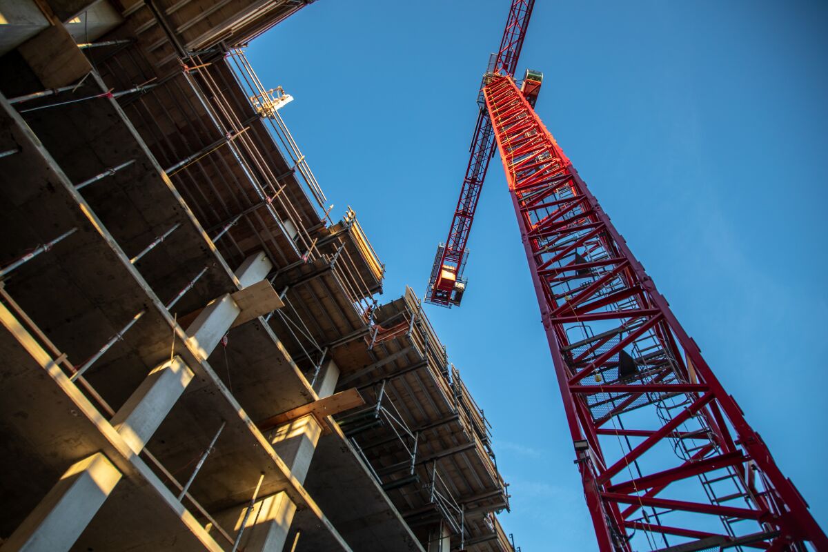 A crane at a housing construction site.