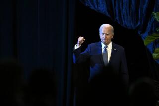 President Joe Biden walks on stage to speak