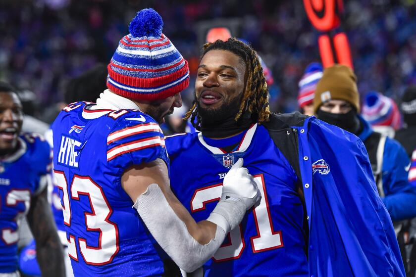 Buffalo Bills safety Damar Hamlin, right, celebrates with safety Micah Hyde after an NFL game against the New York Jets