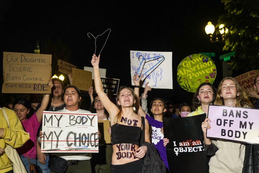 A crowd gathers outside the Supreme Court on Monday night after a purported leak says that Roe vs. Wade will be overturned on May 2, 2022.