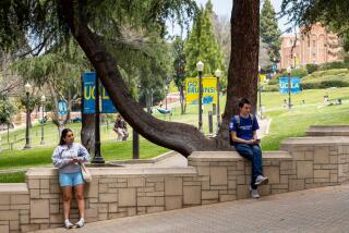 Los Angeles, CA - May 17: Signage and people along Bruin Walk East, on the UCLA Campus in Los Angeles, CA, Wednesday, May 17, 2023. (Jay L. Clendenin / Los Angeles Times)