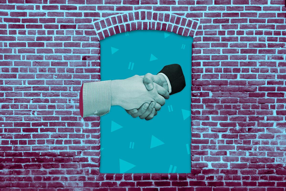 a business handshake through an opening in a brick wall against a backdrop of play and pause icons