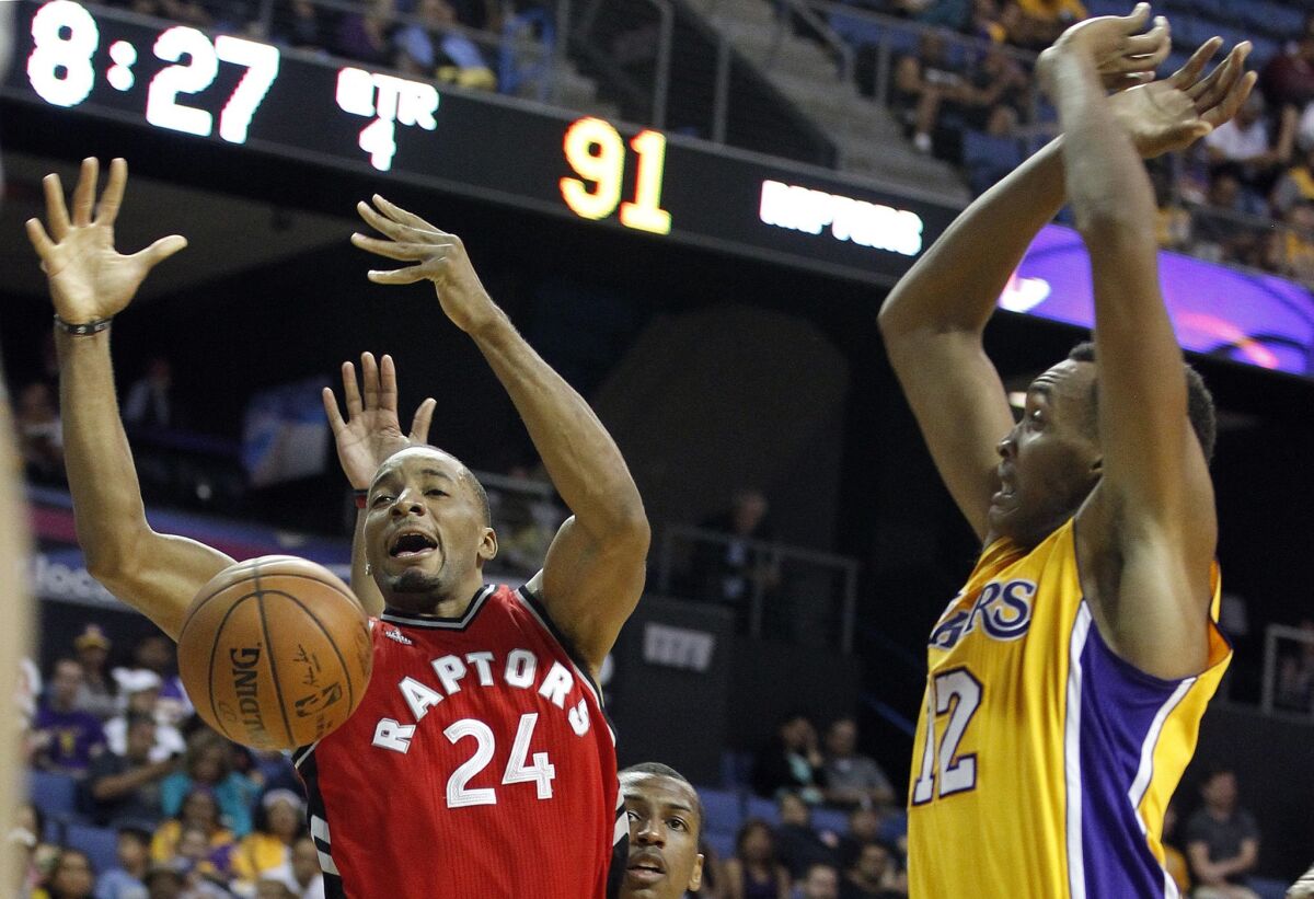 Lakers center Robert Upshaw, right, knocks the ball away from Raptors guard Norman Powell during a preseason game on Oct. 8 in Ontario.