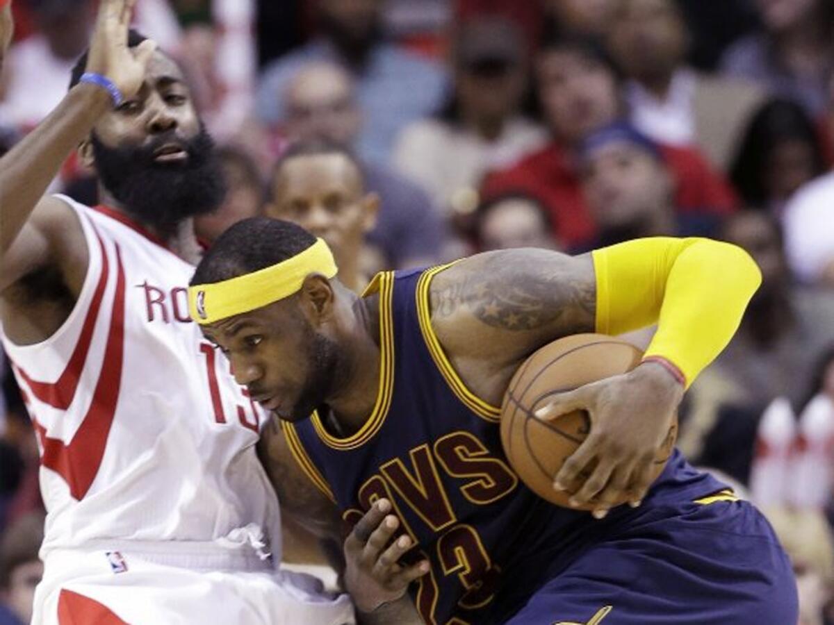 Rockets guard James Harden tries to defend Cavaliers forward LeBron James during the second half of the Rockets' 105-103 overtime victory.