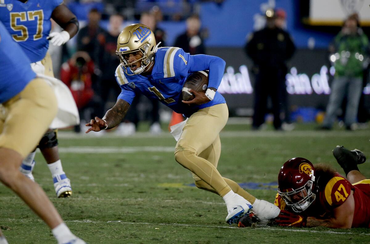 Dorian Thompson-Robinson runs for UCLA.