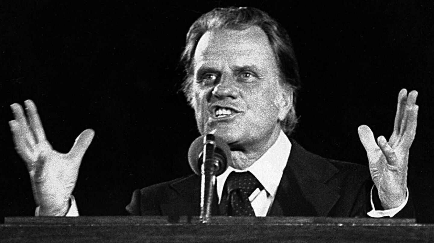 The Rev. Billy Graham addresses a crowd in Seattle during the Graham Crusade in 1976.