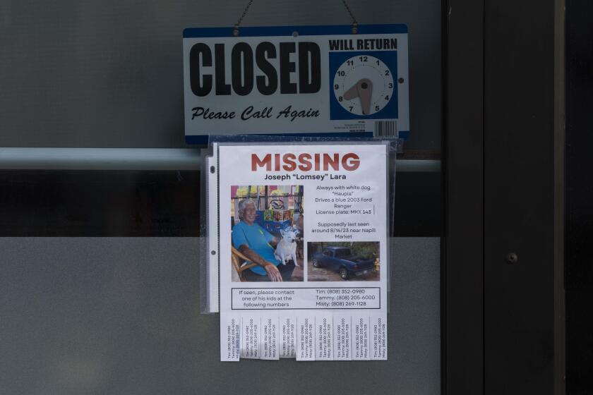 A missing person flyer for Joseph "Lomsey" Lara is posted on the door of a business in a shopping mall in Lahaina, Hawaii, Monday, Aug. 21, 2023. Wildfires devastated parts of the Hawaiian island of Maui earlier this month. (AP Photo/Jae C. Hong)