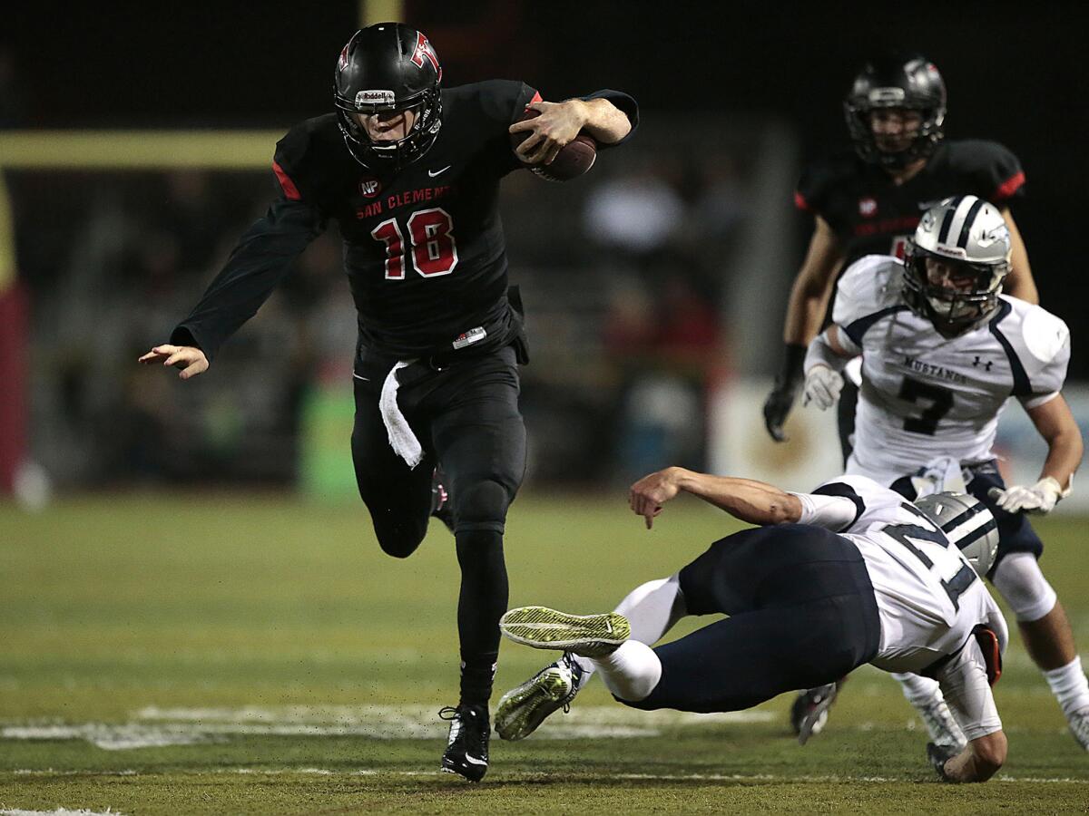 San Clemente quarterback Sam Darnold breaks a tackle for a long run during the second quarter of a CIF Southwest Division game on Dec. 5. Darnold signed a letter of intent on Wednesday with USC.
