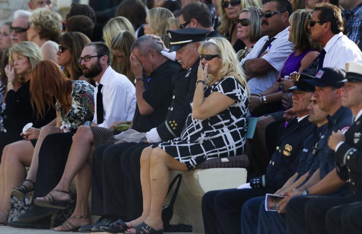 Christopher MacKenzie's parents, Michael MacKenzie and Lauri Goralski, right center, are brought to tears during a memorial service at the Ramona Bowl Amphitheater in Hemet.