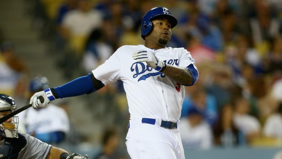 Dodgers left fielder Carl Crawford hits a run-scoring double in the eighth inning of a 4-0 win over the San Diego Padres on Wednesday.