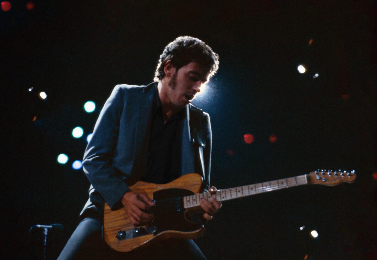 Bruce Springsteen in 1979, playing guitar onstage.