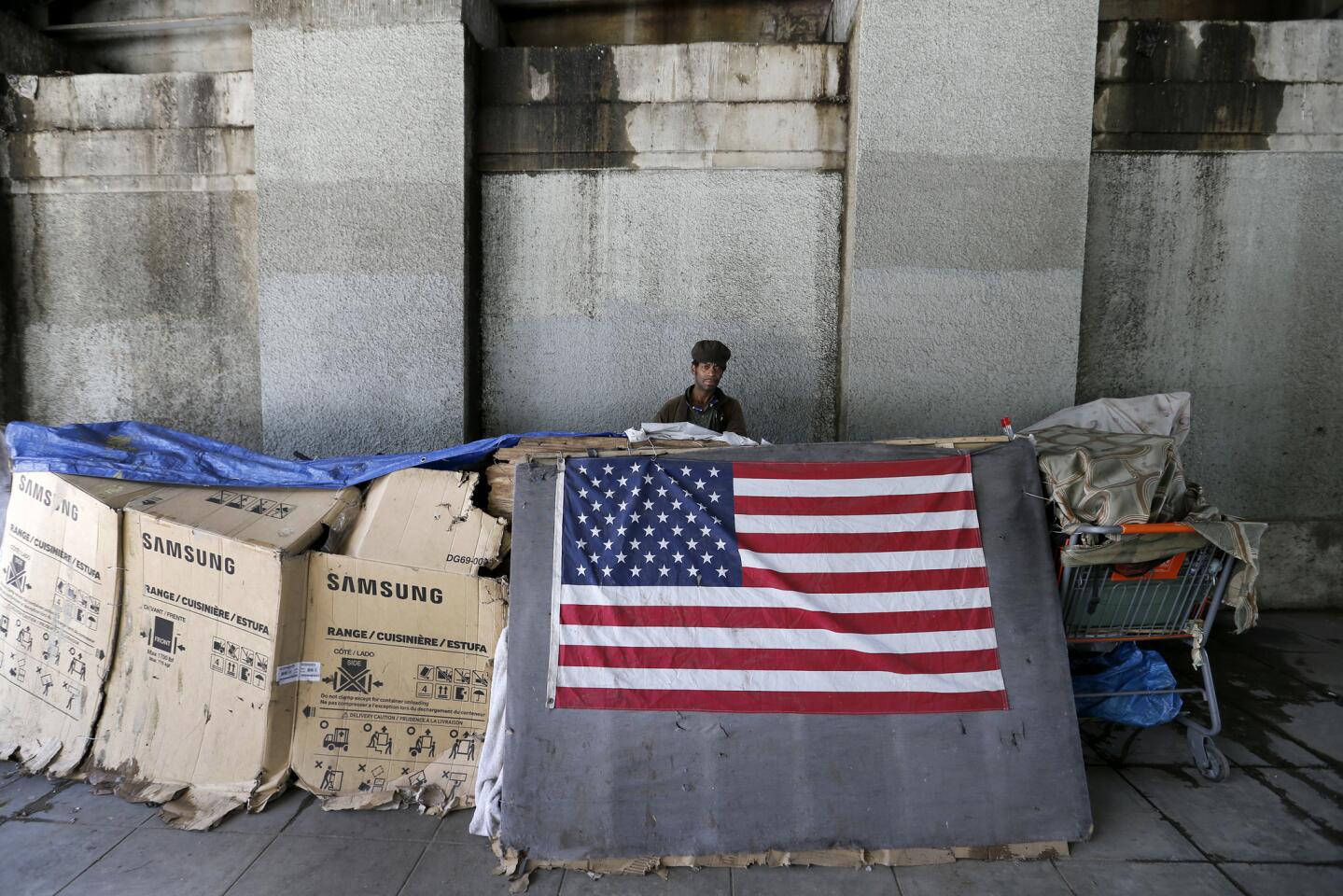 Anthony Tolliver, who has been homeless for 30 years, moved to another bridge after Caltrans workers started cleaning up and removing debris from a tented homeless community under the 101 Freeway bridge on Hoover Street in Historic Filipinotown