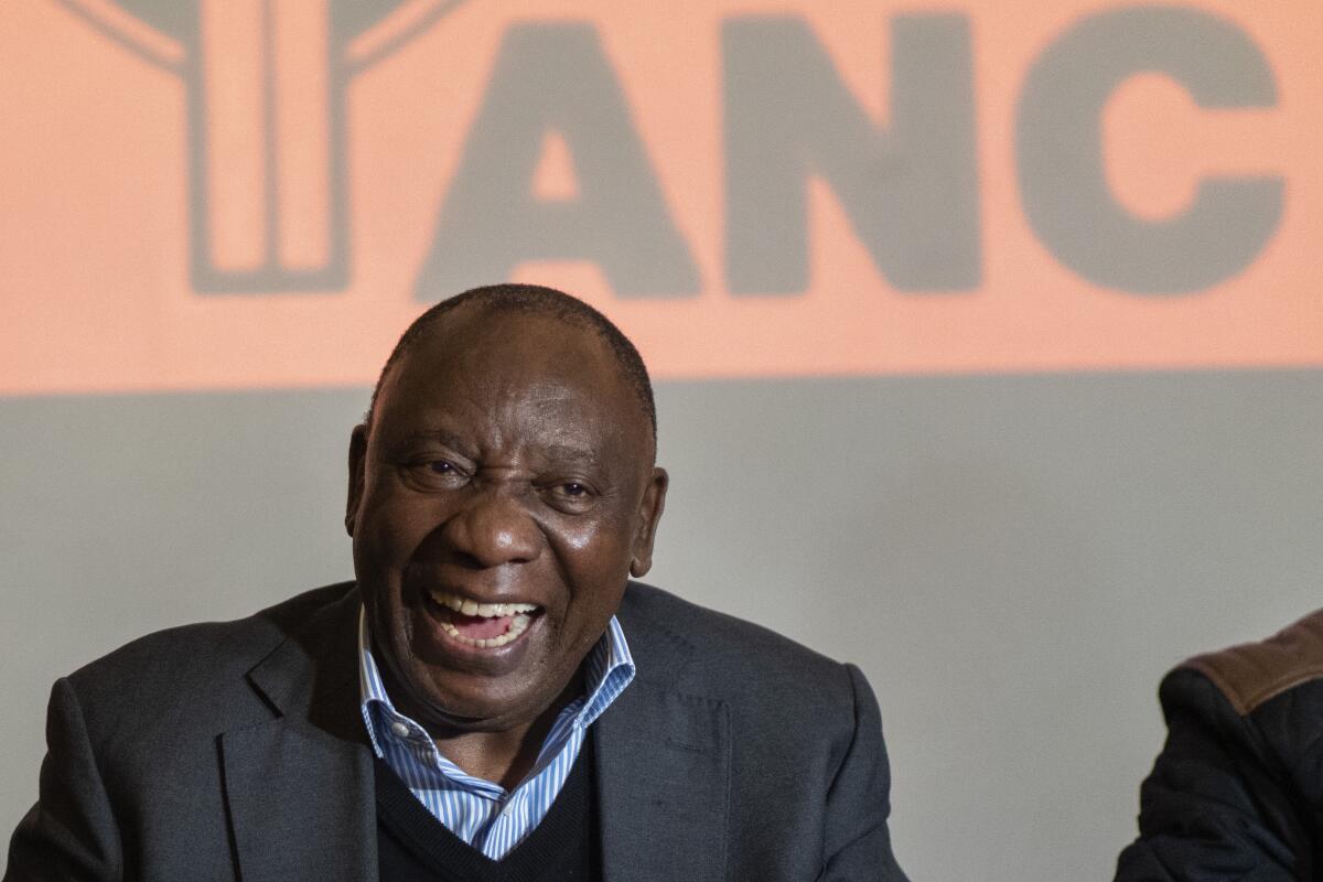 South African President Cyril Ramaphosa laughs during a meeting