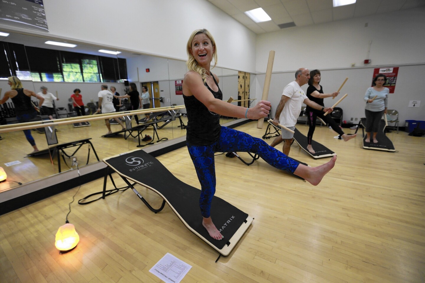Ayla Donlin leads an In-Trinity class at the LifeFit Center on the campus of Cal State Long Beach. It involves stretching, strengthening and balancing exercises on a slant board.