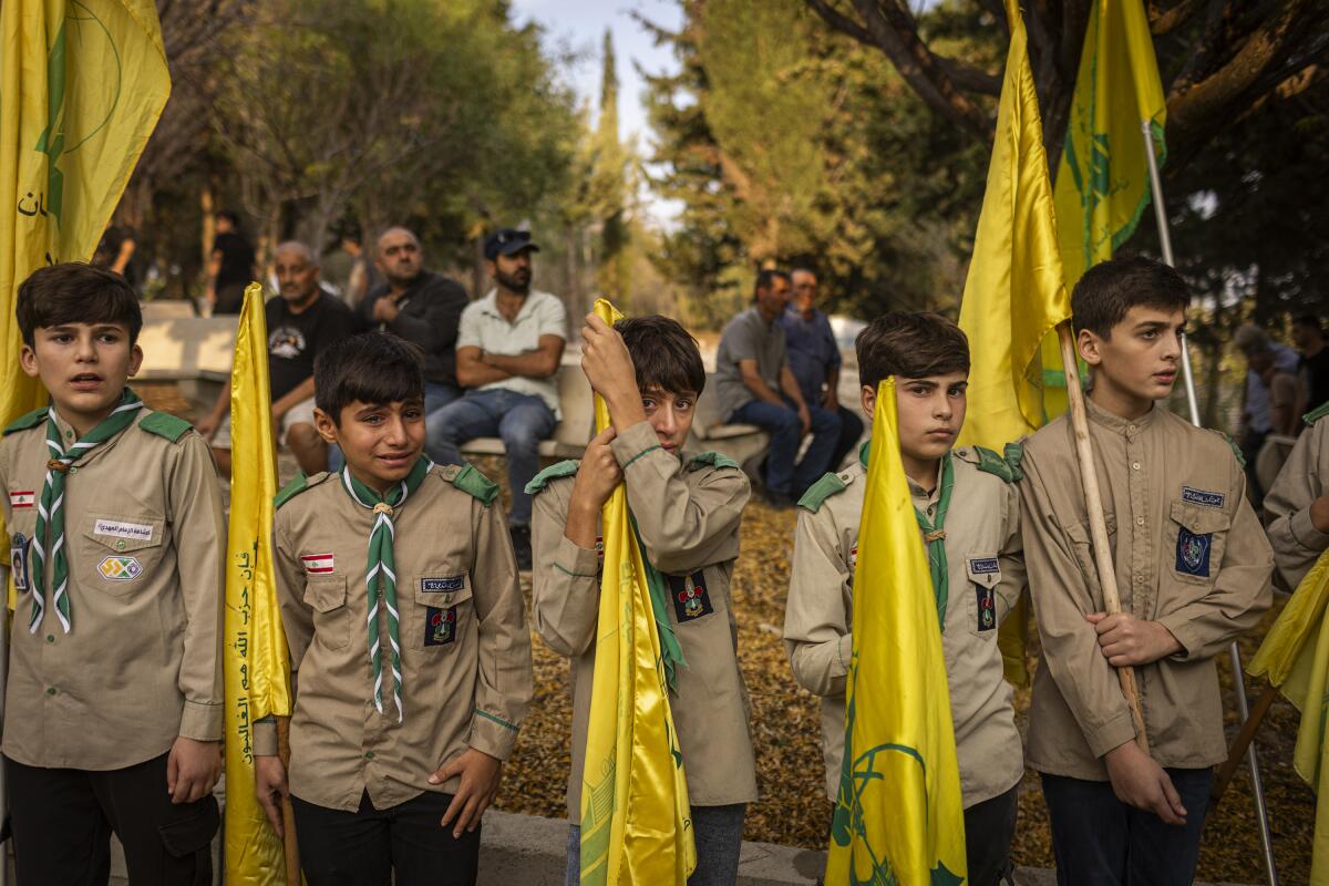 Relatives of Ali Kourani, 16, who was killed by an Israeli drone attack in his home town of Yater, mourn over his coffin during his funeral in Yater, Lebanon.