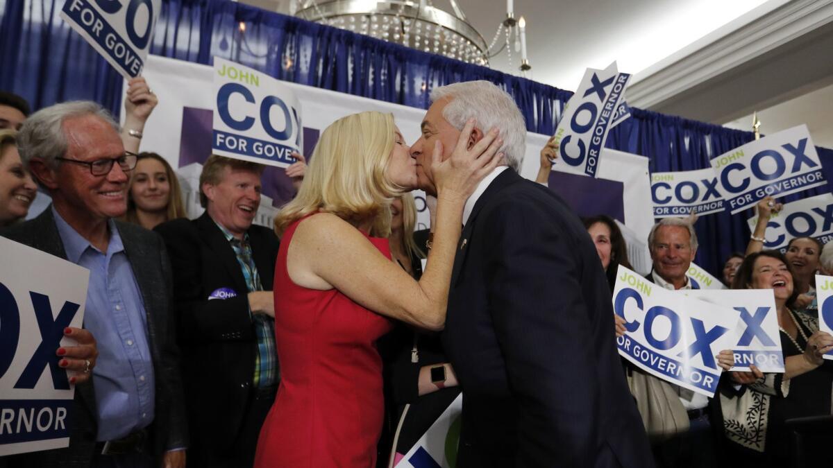 California Republican gubernatorial candidate John Cox is greeted at the podium with a kiss from his wife, Sarah, before speaking at the U.S. Grant Hotel in San Diego.