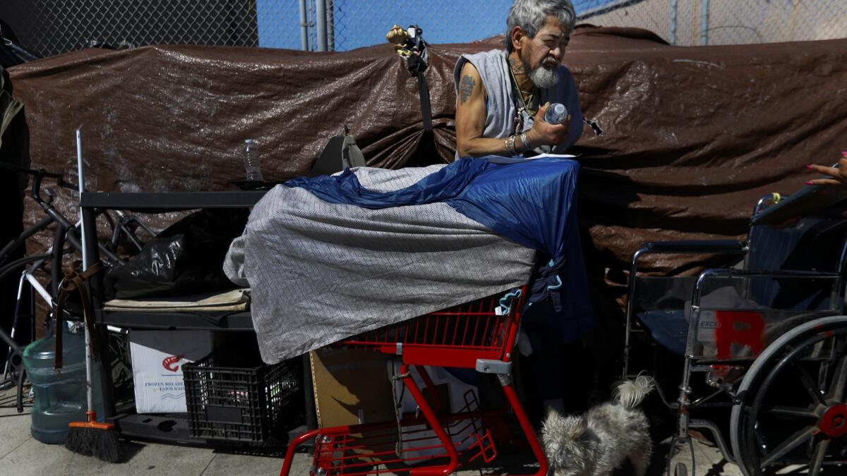 LOS ANGELES, CA MARCH 5, 2018: Santiago Robles, 60, stands outside his tent on South Hope Street in Los Angeles, CA March 5, 2018. Santiago is a homeless man and lives inside the tent with his friend and his dog. (Francine Orr/ Los Angeles Times)