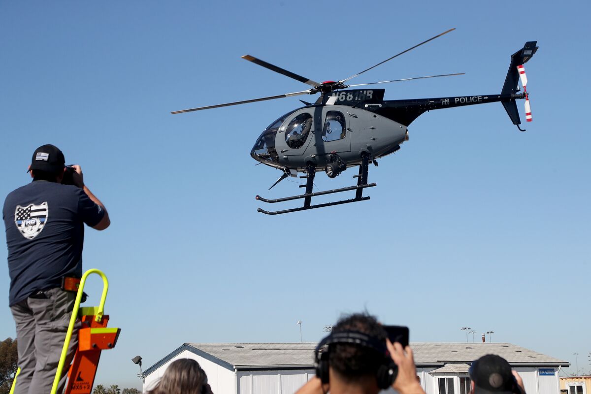 A new police helicopter, flown by pilot Tyler Hanson and co-pilot Jon Deliema, flies by members of the media on Wednesday.