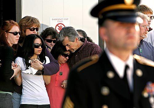 The family of Sgt. David Hart gathers around his widow, Nicole, second from left, as the soldier's remains are returned from Iraq to Long Beach Airport.