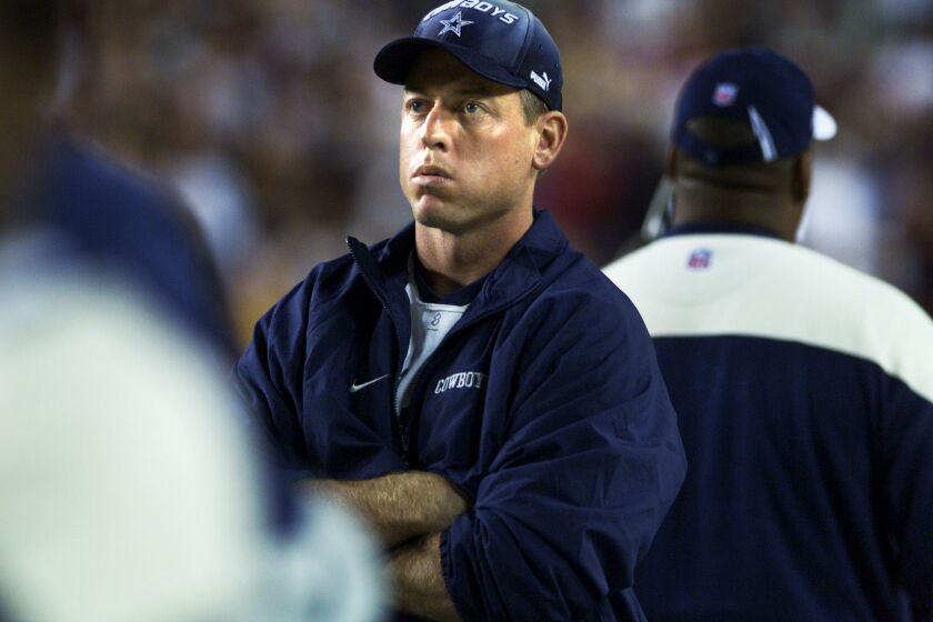 Injured Dallas Cowboy Quarterback Troy Aikman looks on from the sidelines as the officials examine the replay of a Dallas fumble against the Washington Redskins in Landover, MD 18 September 2000. The Cowboys won, 27-21. AFP PHOTO/ SHAWN THEW (Photo by SHAWN THEW / AFP) (Photo credit should read SHAWN THEW/AFP via Getty Images)
