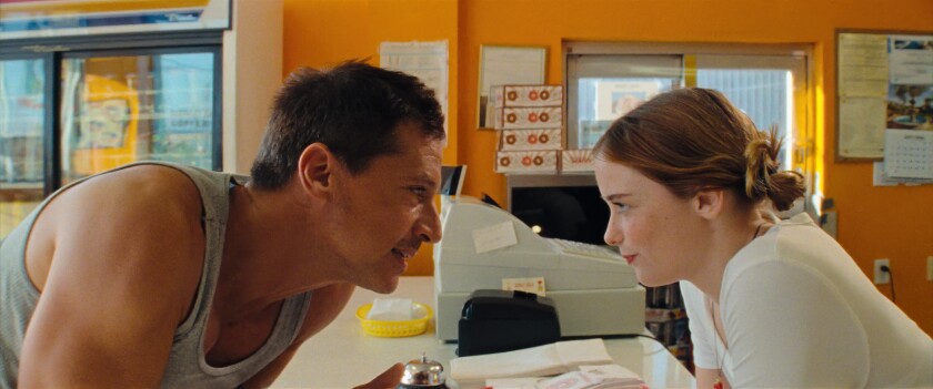 This image released by A24 Films shows Simon Rex, left, and Suzanna Son in a scene from "Red Rocket." (A24 via AP)