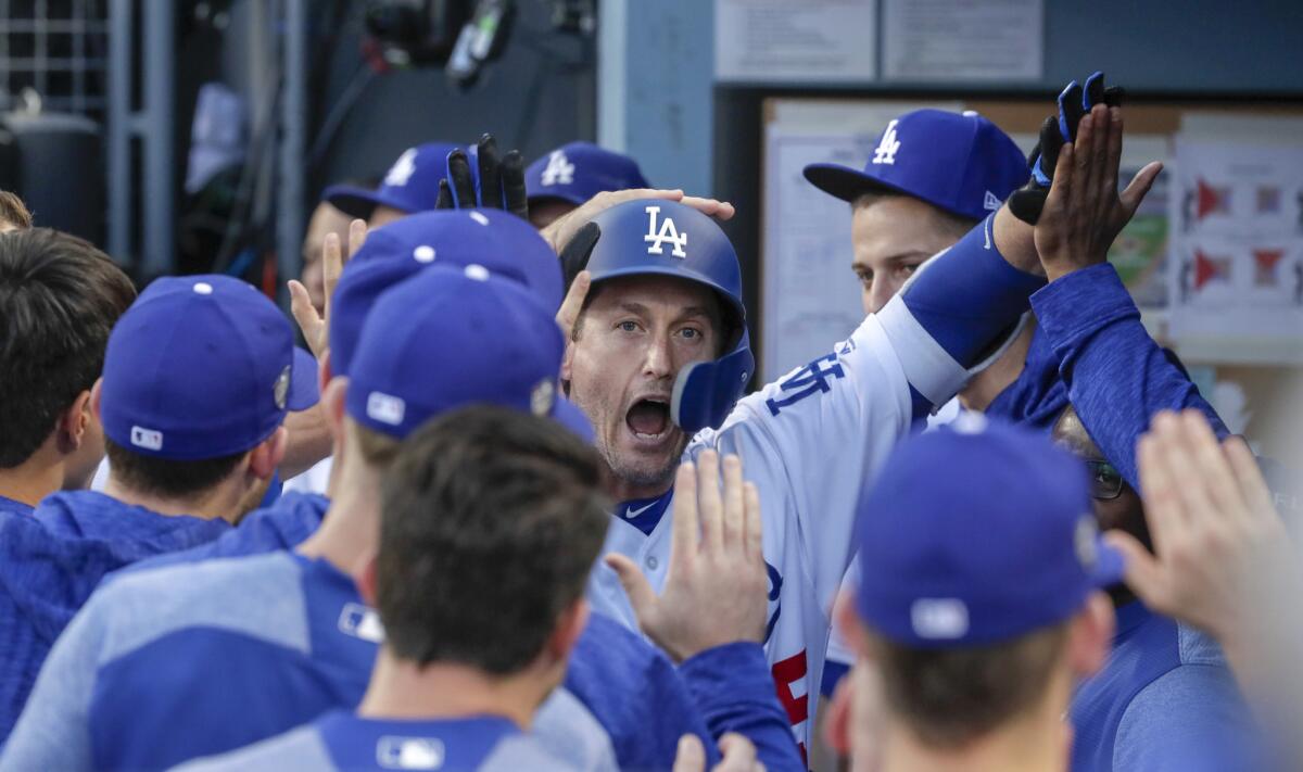 David Freese, a veteran who the Dodgers added to their roster late in the season, celebrates in the dugout after hitting a home run to lead off the first inning.
