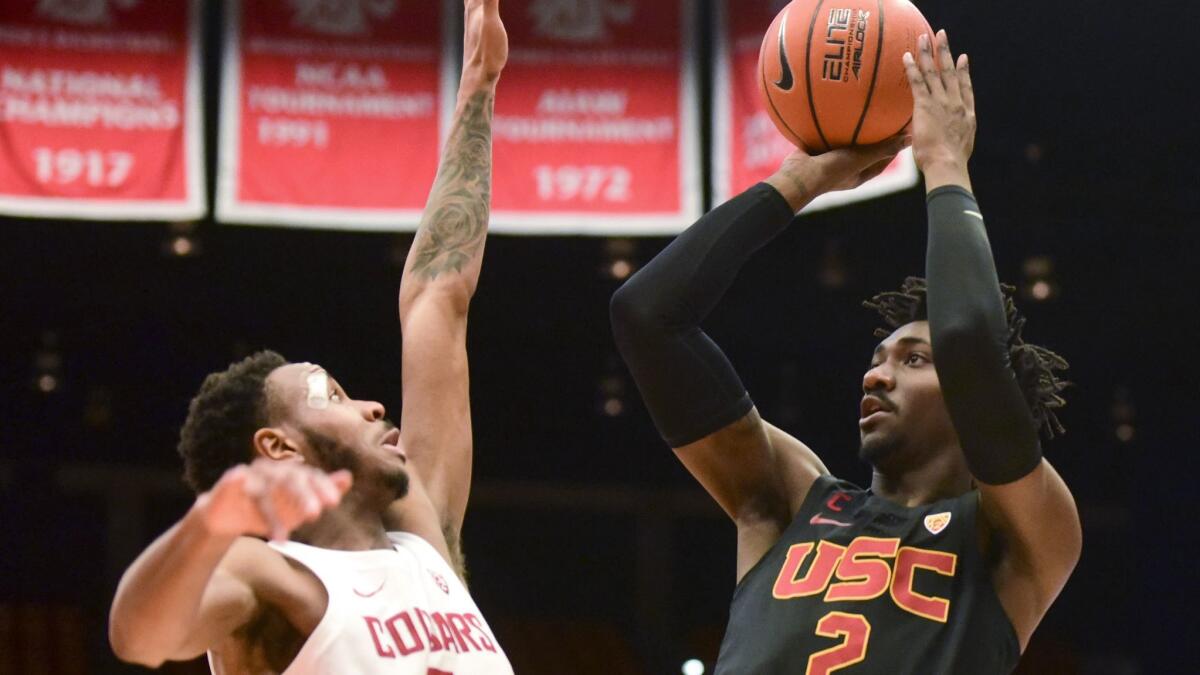 USC guard Jonah Mathews shoots as Washington State forward Marvin Cannon defends during the first half on Saturday.