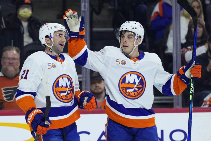 New York Islanders' Kyle Palmieri, left, and Jean-Gabriel Pageau celebrate after a goal by Palmieri during the first period of an NHL hockey game against the Philadelphia Flyers, Monday, Feb. 6, 2023, in Philadelphia. (AP Photo/Matt Slocum)