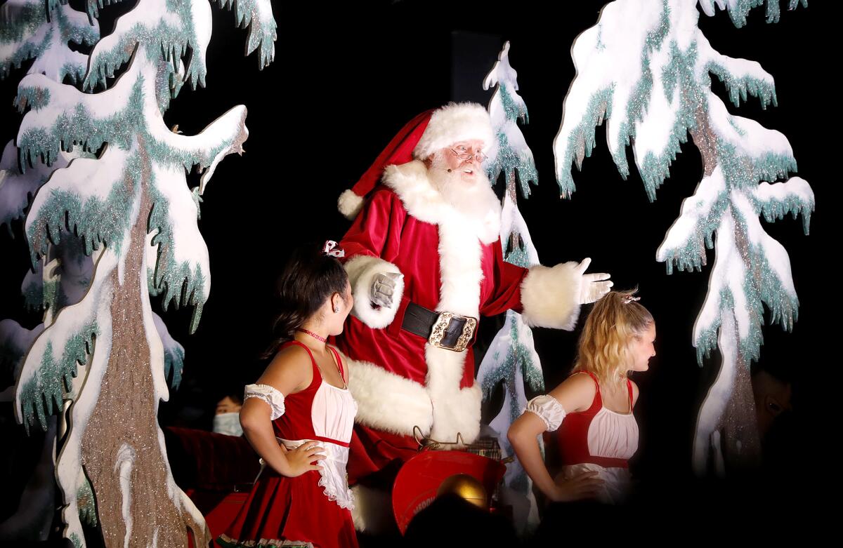 Santa Claus prepares the audience for the tree lighting at South Coast Plaza on Thursday.