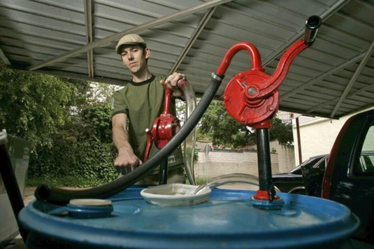 GREEN IDEA: Matthew Tiffany, 26, of Monrovia fills his 1981 diesel Mercedes with fryer grease from a neighborhood restaurant. His effort to launch a fuel cooperative failed because of red tape.
