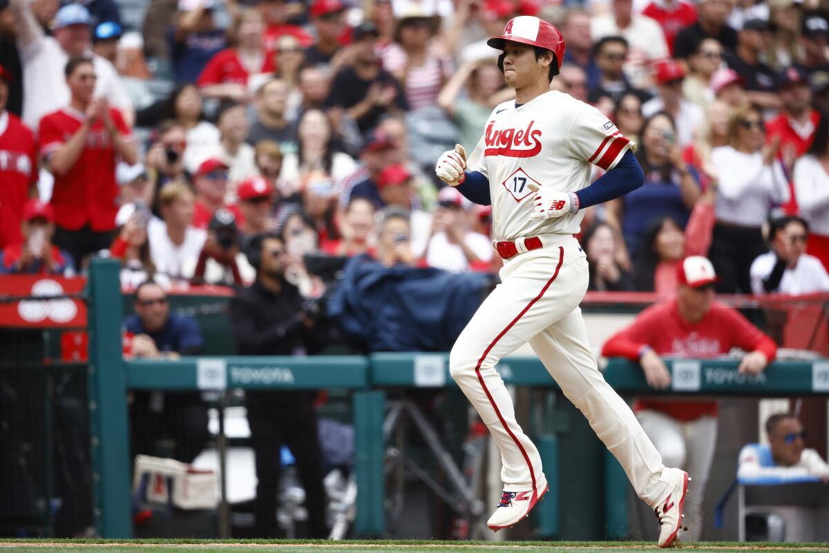 Shohei Ohtani scores for the Angels in the third inning against the Seattle Mariners on Sunday at Angel Stadium.