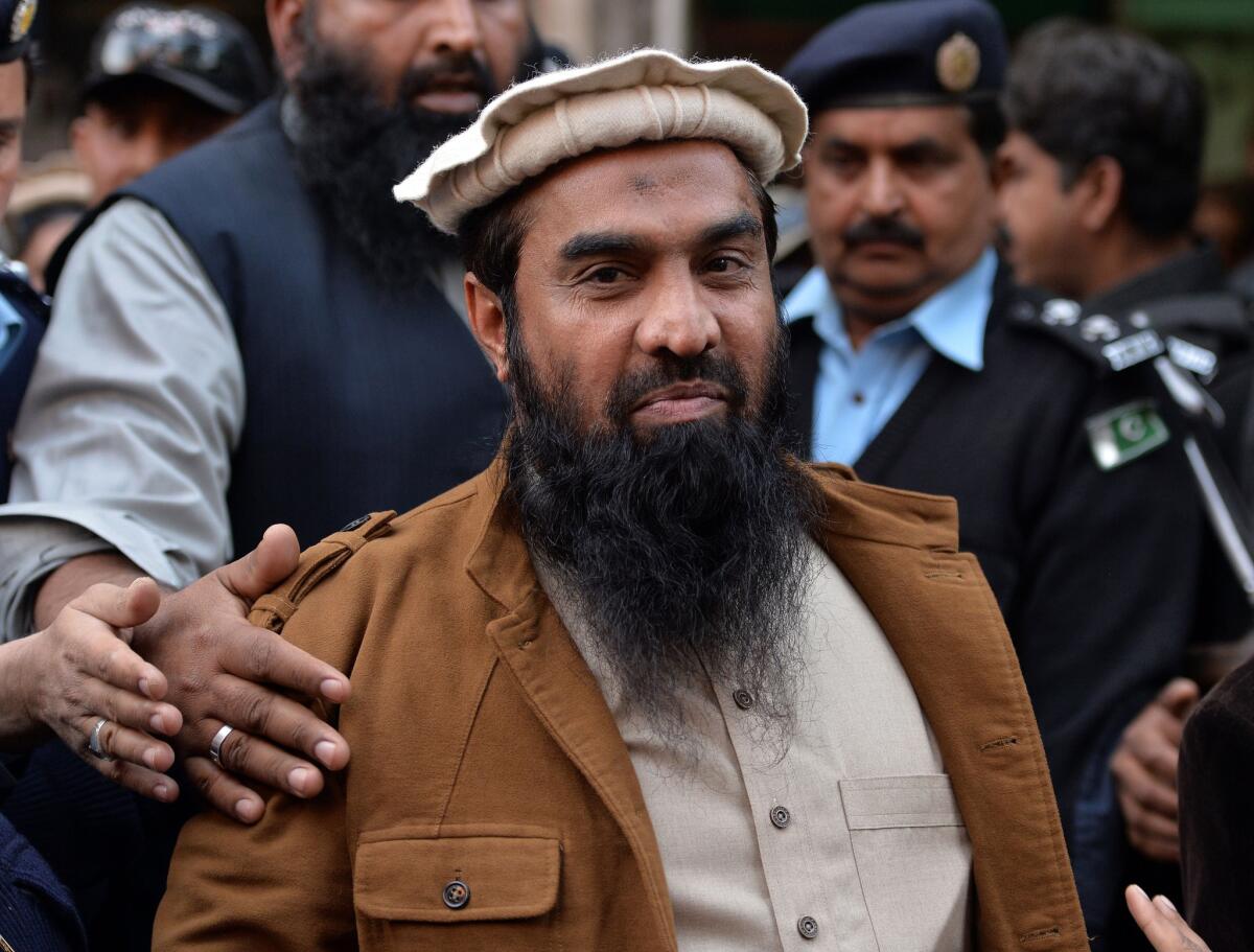 Pakistani security personnel escort Zaki-ur Rehman Lakhvi as he leaves court after a hearing in Islamabad on Jan. 1.