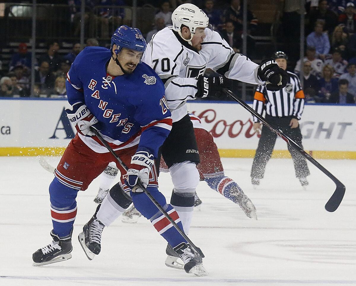 Kings forward Tanner Pearson, right, delivers an open-ice hit on New York Rangers forward Chris Kreider during the Kings' 2-1 loss in Game 4 of the Stanley Cup Final.