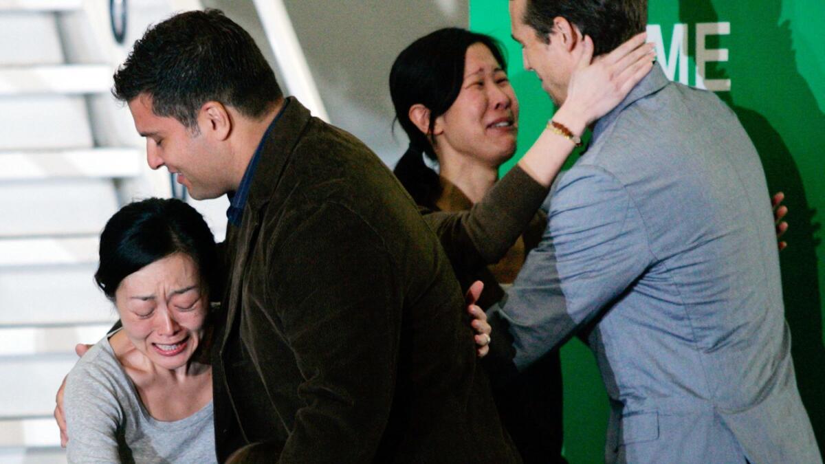 Aug. 5, 2009: Euna Lee, left, and Laura Ling embrace family members upon arriving at Bob Hope Airport in Burbank.