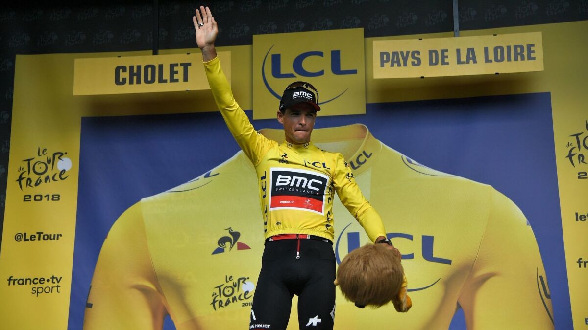Belgium's Greg Van Avermaet, wearing the yellow jersey, waves from the podium on Monday.
