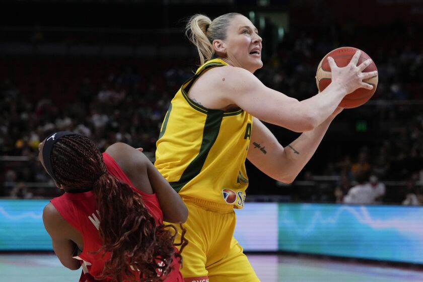 Australia's Lauren Jackson, right, attempts a shot as Japan's Stephanie Mawuli falls during their game at the women's Basketball World Cup in Sydney, Australia, Tuesday, Sept. 27, 2022. (AP Photo/Mark Baker)