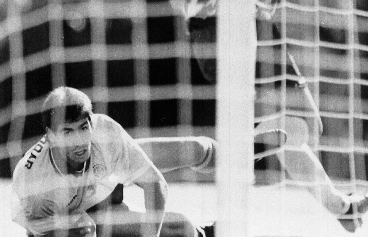 Colombia's Andres Escobar lies on the ground and watches as a shot by the U.S.'s Eric Wynalda misses the goal on June 22, 1994.