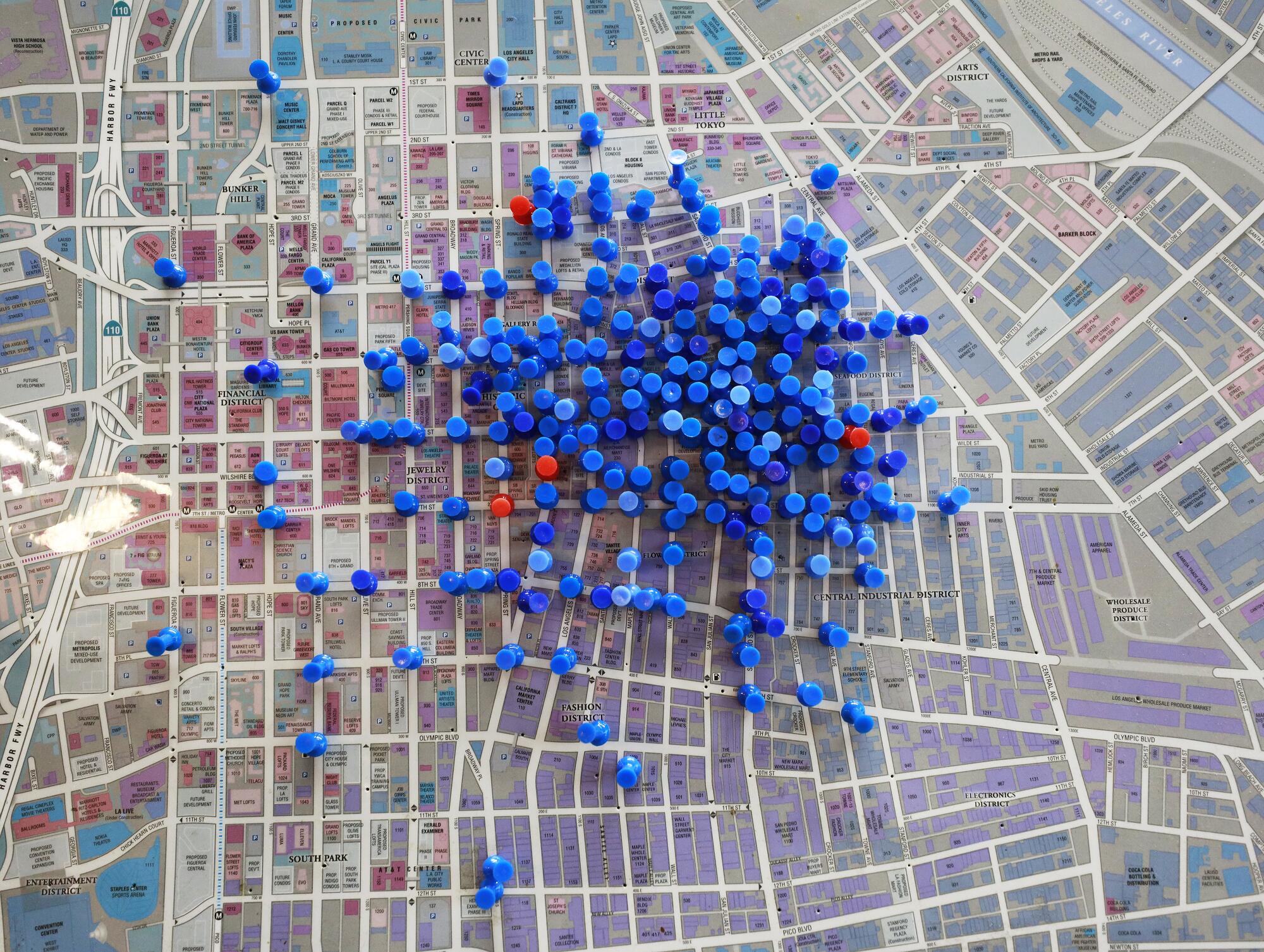 A map of downtown L.A. displays overdose reversals with blue pins while the red pins show overdose fatalities.