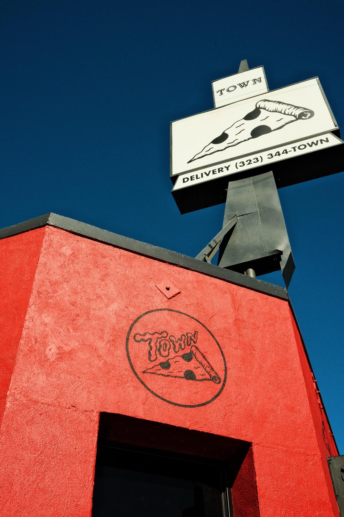 An exterior of the red-colored Town pizza in Highland Park.