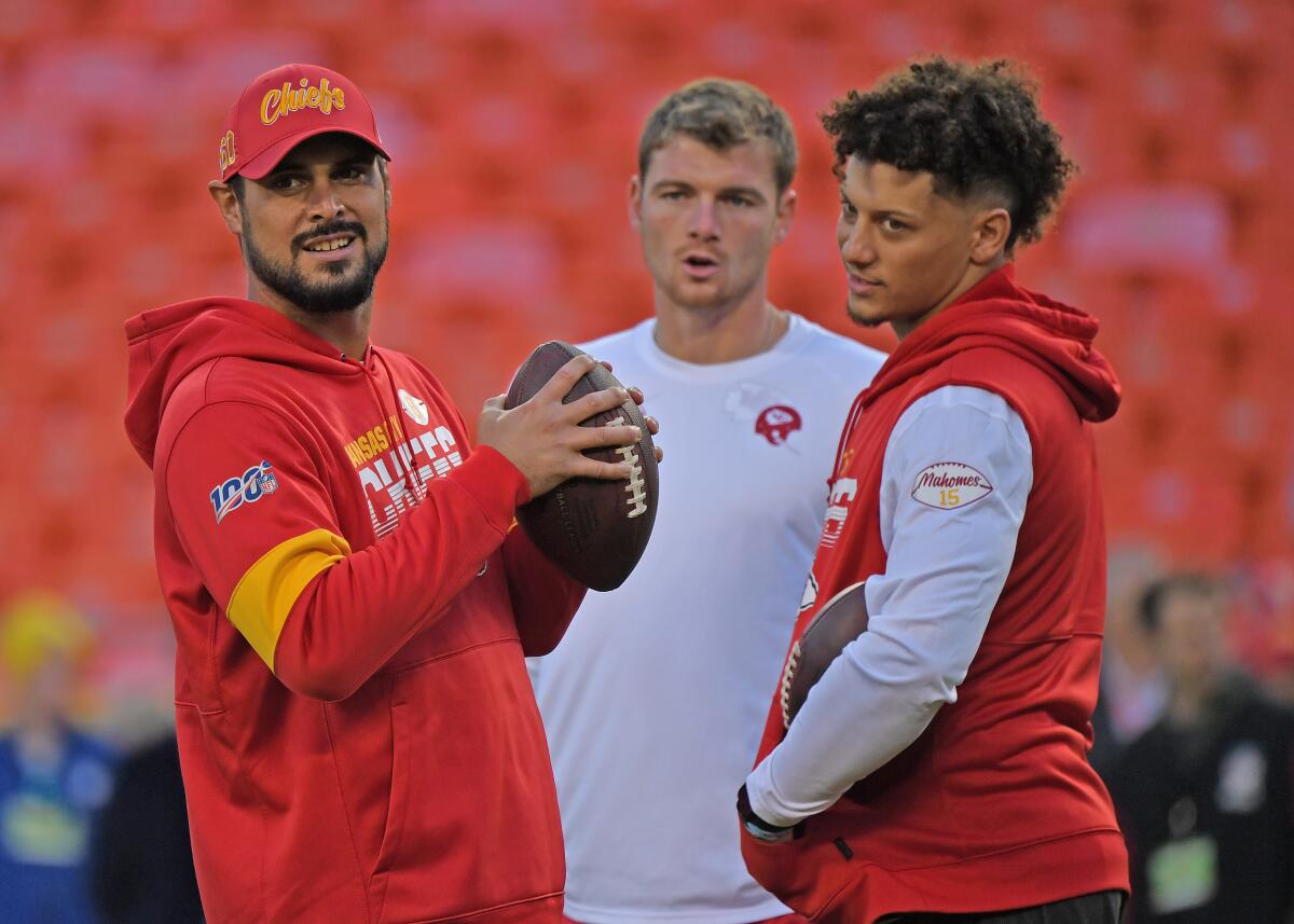 From left, quarterbacks Matt Moore, Kyle Shurmur and  Patrick Mahomes share a moment before a game in October.