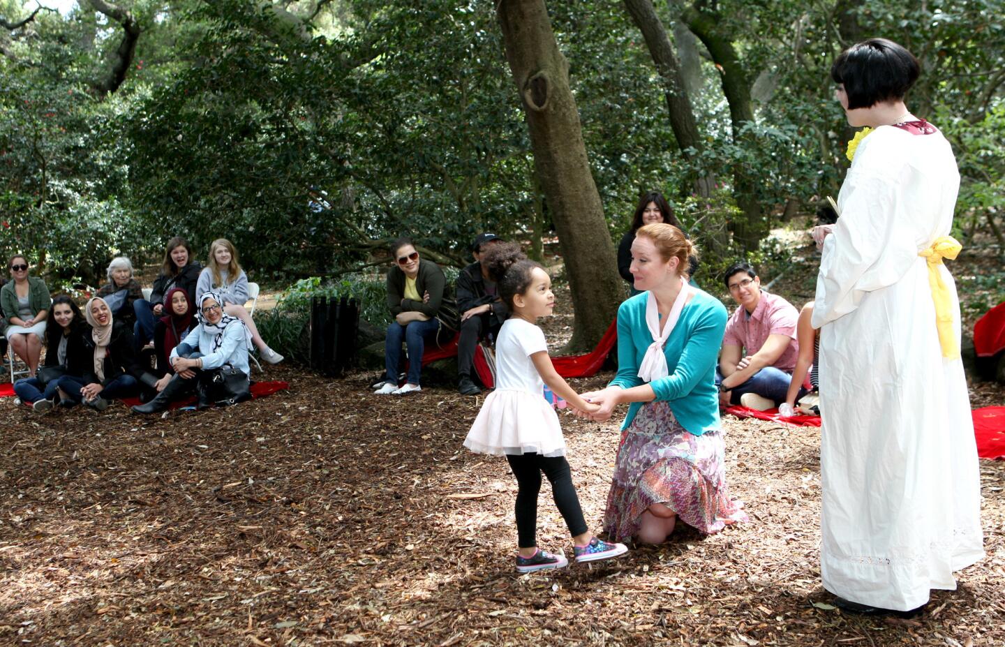 Ensemble Shakespeare Theater actor Megan Pyle, center, holds Amila Monkewitz's hand while actor Anastasia Leddick, right, performs a Shakespeare sonnet at Descanso Gardens in La Ca–ada Flintridge on Saturday, April 8, 2017.